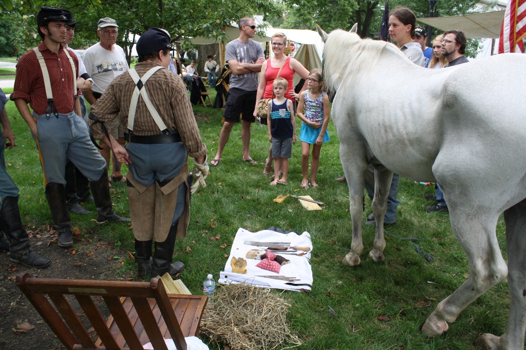 Dude helps Marti demonstrate horse hoof care and trimming